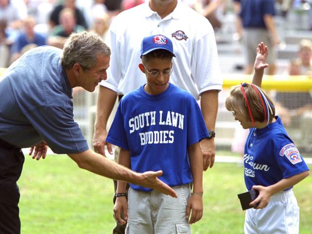 President George W. Bush congratulates members of the Waynesboro, Virginia Little League Challenger Division Sand Gnats after their Tee Ball on the South Lawn game, September 22, 2002.