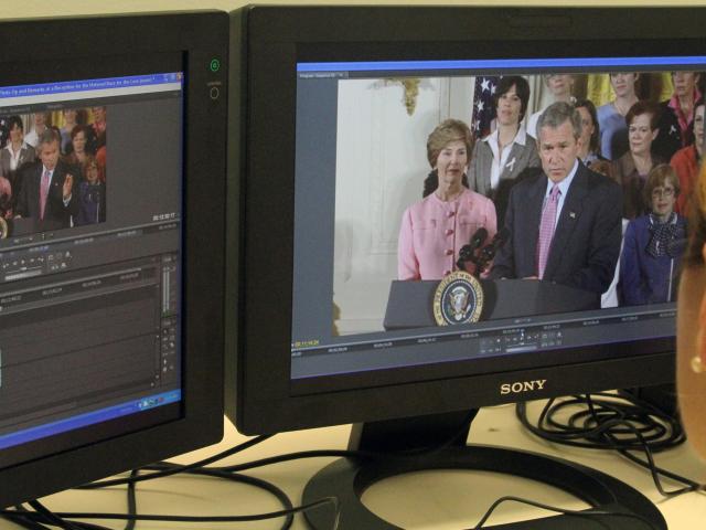 An archivist reviews audiovisual materials.