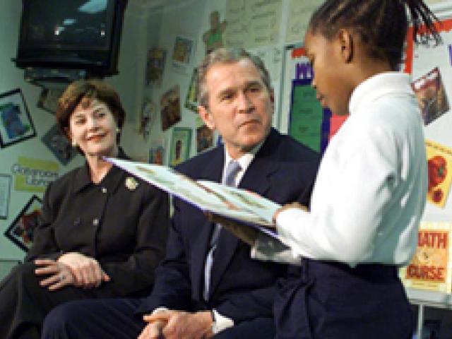 President George W. Bush and First Lady Laura Bush listen to student Janea Bufford read at Moline Elementary School in St. Louis, Missouri on February 20, 2001. (P20010220-4B)