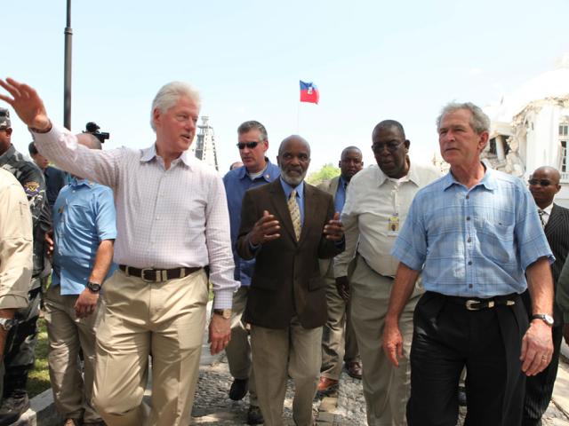 Presidents George W. Bush and Bill Clinton survey damage en route to Palace West Camp during a visit to Haiti on March 22, 2010.