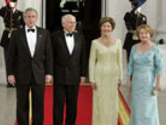 President George W. Bush and Mrs. Laura Bush stand with Australian Prime Minister John Howard and his wife Mrs. Janette Howard for a photograph during the official dinner, May 16, 2006.