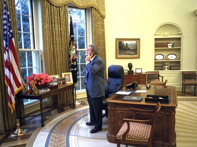 President George W. Bush places calls to the families of the crew of the space shuttle Columbia, February 1, 2003, from the Oval Office of the White House. (P26340-16)