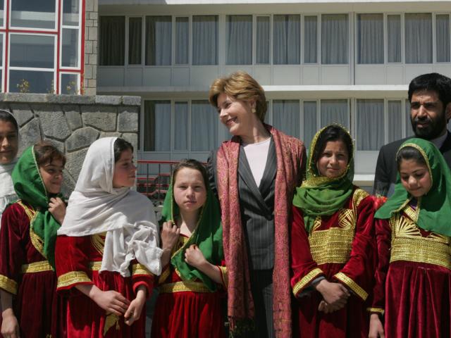 First Lady Laura Bush stands with a group of Afghan girls on hand to greet her, March 30, 2005, upon her arrival in Kabul. (P44656-322)