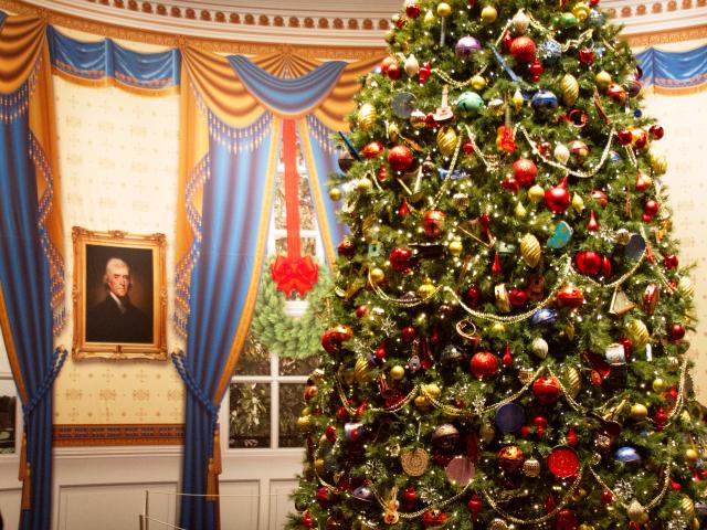 A photo of a replica Blue Room Christmas Tree decorated in the 2004 White House holiday theme 'A Season of Merriment and Melody,' part of the 2016 Holiday exhibit at the George W Bush Library and Museum 