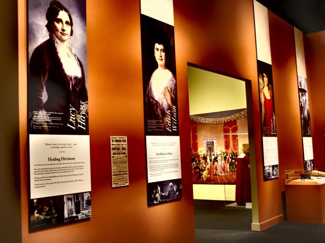 A photo including pictures of Lucy Hayes and Edith Wilson from the 2018 First Ladies exhibit at the George W Bush Library and Museum