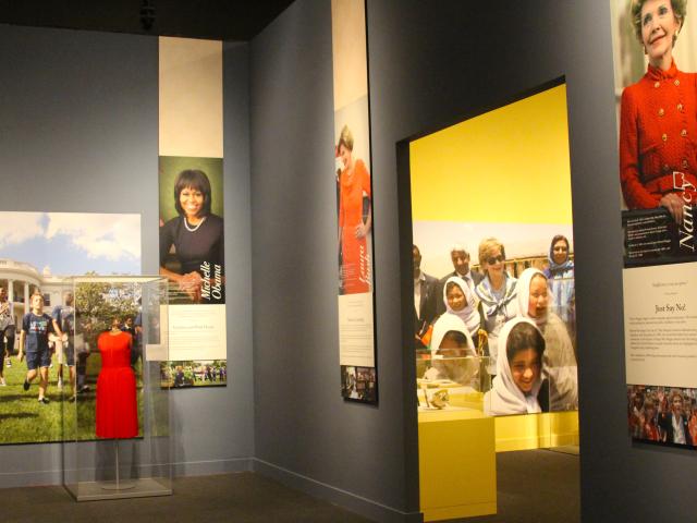 A photo showing two rooms in the 2018 First Ladies exhibit at the George W Bush Library and Museum, featuring pictures of Nancy Reagan, Laura Bush and Michelle Obama