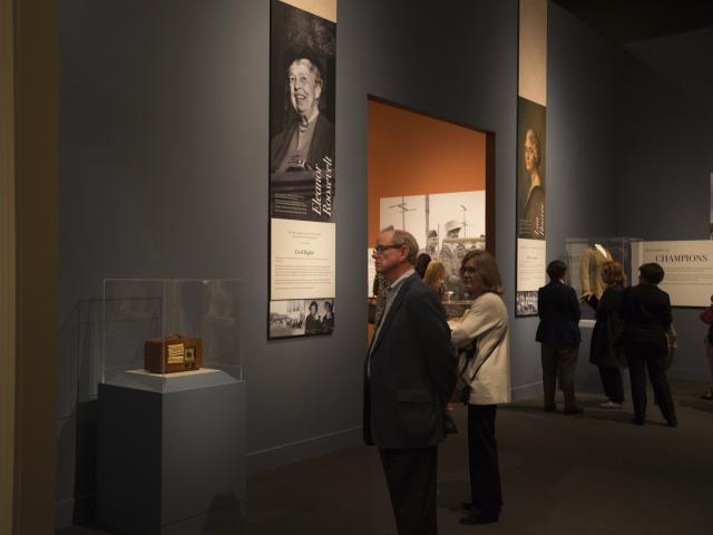 A picture of visitors looking at an old radio display in the 2018 First Ladies exhibit at the George W Bush Library and Museum