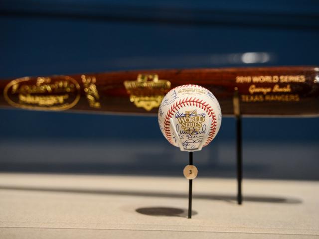 A close-up picture of an autographed World Series baseball in a display case, part of the 2015 exhibit 'Baseball: America's Presidents, America's Pastime,' at the George W Bush Library and Museum