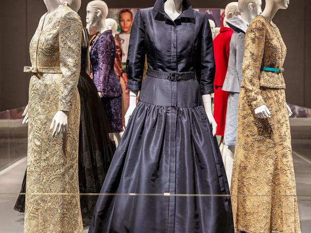 A photo of a display of mannequins wearing formal dresses, part of the 2014 exhibit 'Oscar De La Renta: Five Decades of Style,' at the George W Bush Library and Museum