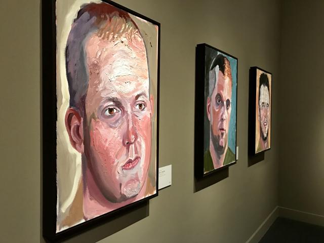 A photo of three portraits painted by President George W Bush, including one of Ben Dellinger, from the 2017 exhibit Portraits of Courage, at the George W Bush Library and Museum