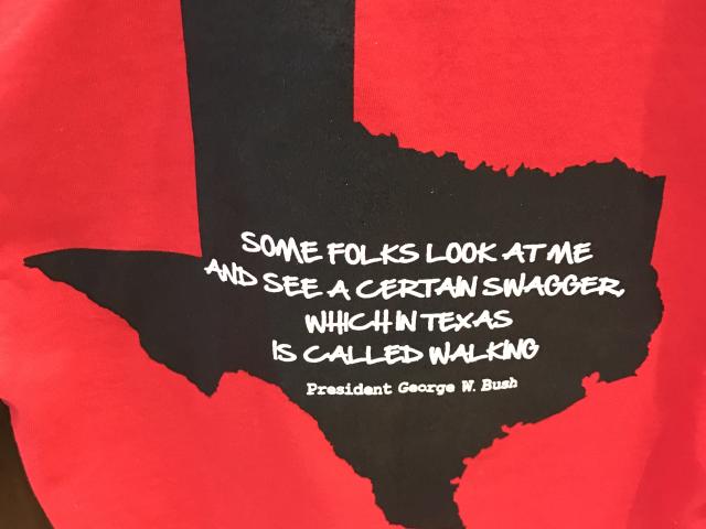 A photo featuring the shape of the state of Texas with a George W Bush quotation, 'Some folks look at me and see a certain swagger, which in Texas is called walking,' from the 2017 exhibit Portraits of Courage, at the George W Bush Library and Museum 