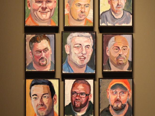 A photo of a wall display featuring nine portraits painted by George W Bush, part of the 2017 Portraits of Courage exhibit at the George W Bush Library and Museum.