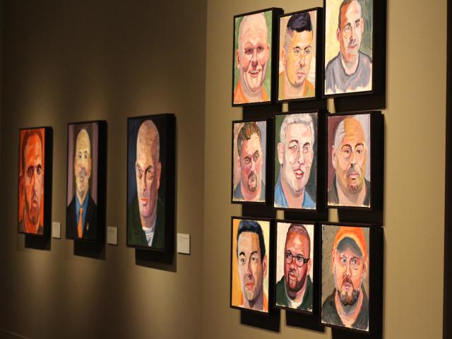 A photo of a wall of portraits painted by President Bush, part of the 2017 exhibit Portraits of Courage, at the George W Bush Library and Museum