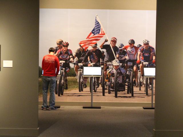 A photo of a bicycle race, part of the 2017 Portraits of Courage exhibit at the George W bush librart.