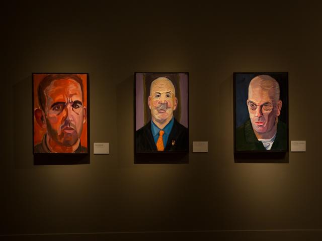A photo of portraits of three men painted by President George W Bush, on a wall of the 2017 exhibit Portraits of Courage, at the George W Bush Library and Museum