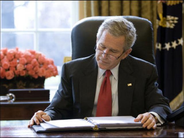 President George W. Bush reads over a draft of his State of the Union in the Oval Office on January 31, 2006.