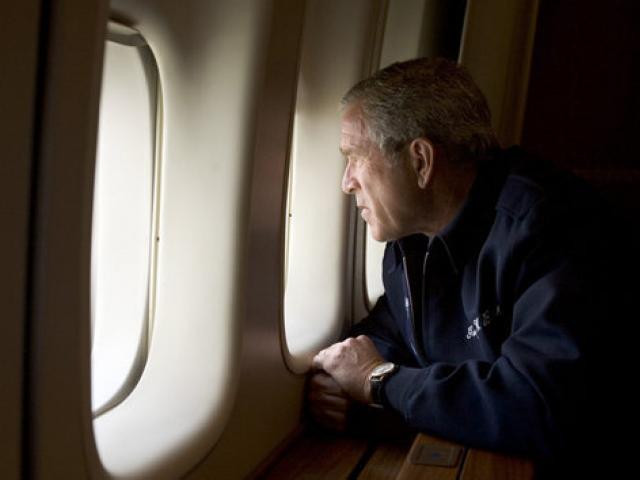 President George W. Bush looks out over the devastation in New Orleans from Hurricane Katrina as he heads back to Washington D.C. Wednesday, Aug. 31, 2005, aboard Air Force One.