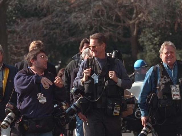 White House Press Pool Photographers walk together, January 24, 2001.