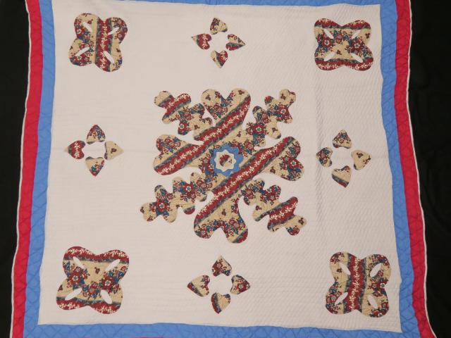 Quilt: handmade by a Liberian women's quilting collective.  Given to Mrs. Laura Bush by President Ellen Johnson-Sirleaf when she visited Liberia for Johnson-Sirleaf's inauguration, January 2006.  (FO.509300.1)