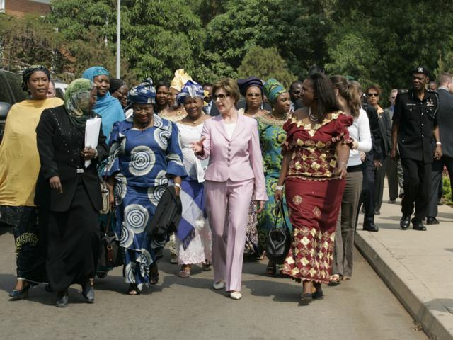 Laura Bush walks with members of the National Center for Women's Development in Abuja, Nigeria to the Women's Hall of Fame January 18, 2006.