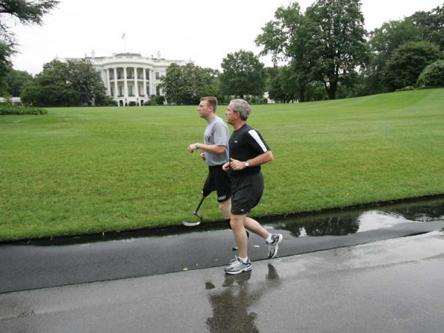 President George W. Bush ran with U.S. Army Staff Sergeant Christian Bagge of Eugene, Oregon, on the South Lawn, June 27, 2006. 