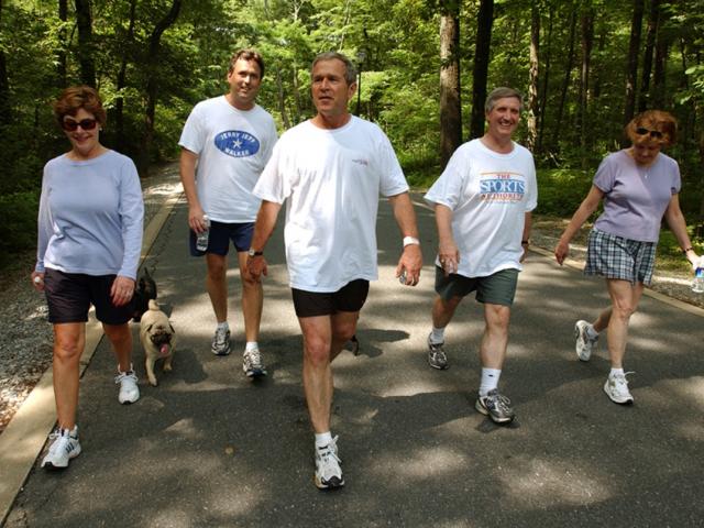 President George W. Bush, First Lady Laura Bush, Marvin Bush, Andy Card and Kathleene Card Walk at Camp David on June 29, 2002. 