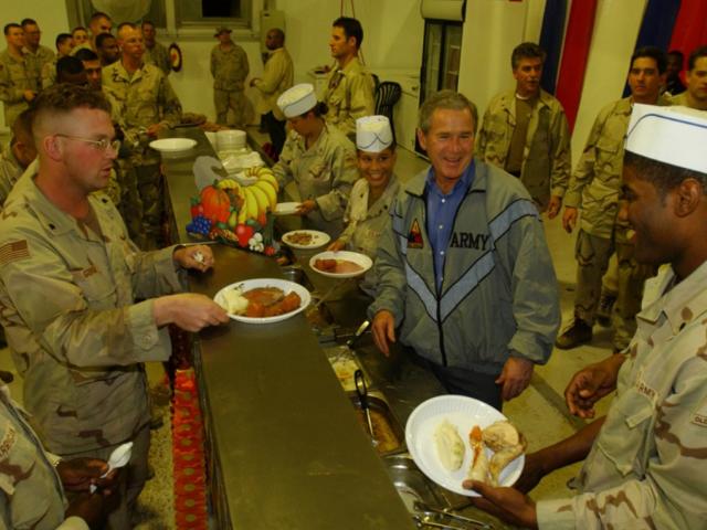 President George W. Bush Meets with Troops and Serves Thanksgiving Dinner at the Bob Hope Dining Facility, Baghdad International Airport, Iraq