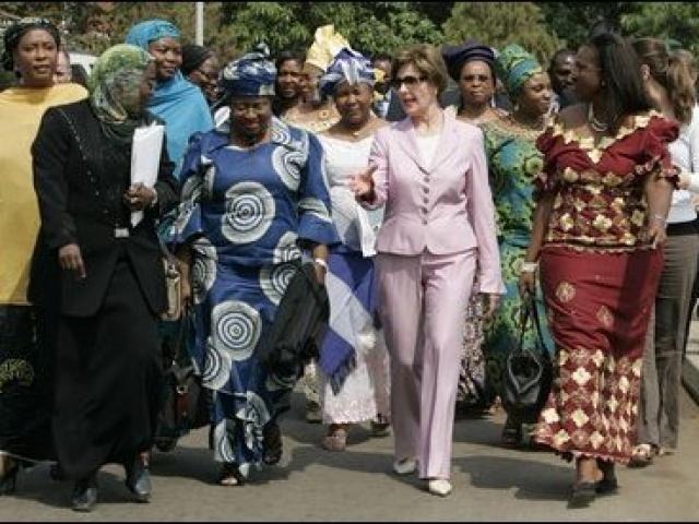 Laura Bush walks with members of the National Center for Women's Development in Abuja, Nigeria to the Women's Hall of Fame January 18, 2006.