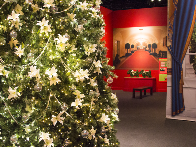 A close up photo of the replica 2005 Blue room Christmas tree showing the fresh lilies and crystal ornaments, part of the 2017 Holiday exhibit at the George W Bush Library and Museum