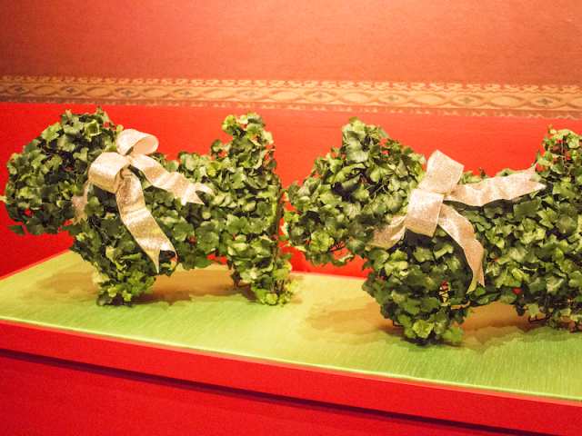 A photo of holiday topiary in the shape of terriers, part of the 2017 Holiday exhibit at the George W Bush Library and Museum