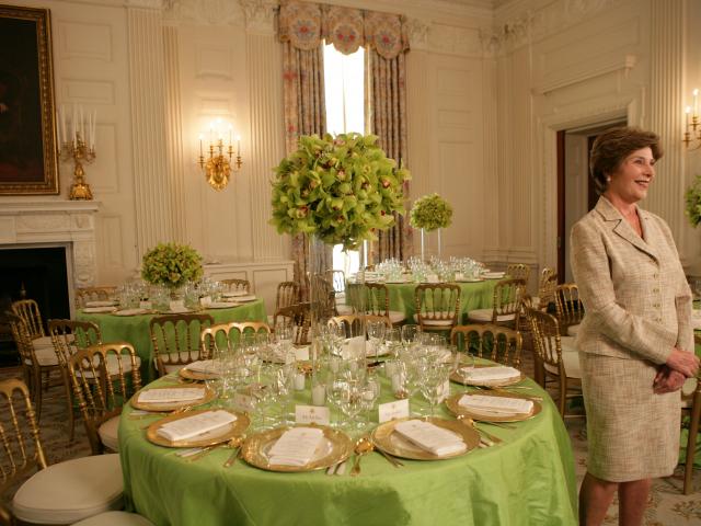 Mrs. Laura Bush with table settings for dinner for Prime Minister Junichiro Koizumi of Japan, June 29, 2006.
