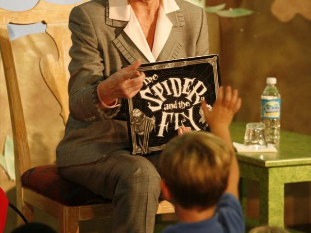 Mrs. Laura Bush reads a book to students