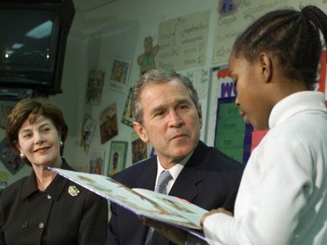 President George W. Bush and Mrs. Laura Bush Listen as Student Janea Bufford Reads Aloud at Moline Elementary School in St. Louis, Missouri.