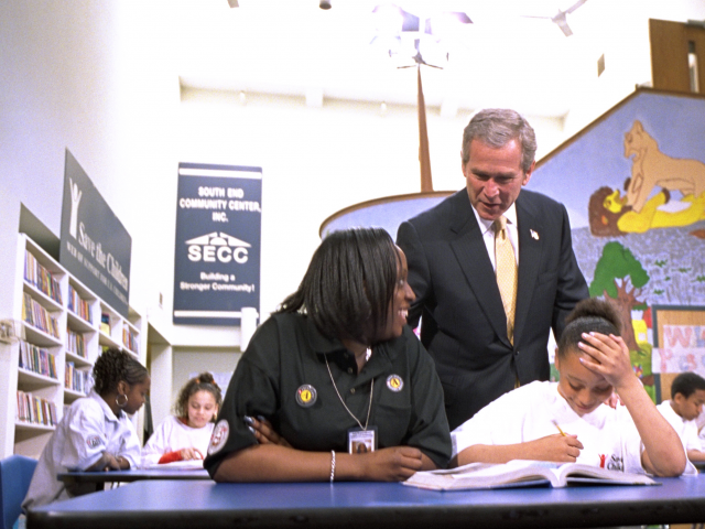 President Bush talks with volunteers and students at a USA Freedom Corps event.