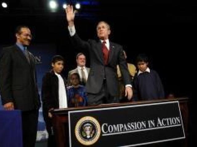 President George W. Bush acknowledges the audience at the White House Regional Conference on Faith-Based and Community Initiatives.