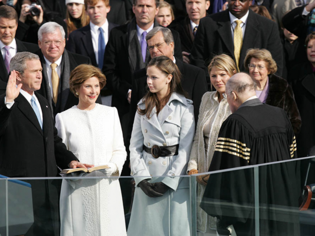 President George W. Bush takes the oath of office to serve a second term as 43rd President of the United States during a ceremony at the U.S. Capitol. Laura Bush, Barbara Bush, and Jenna Bush listen as Chief Justice William H. Rehnquist administers the oath.