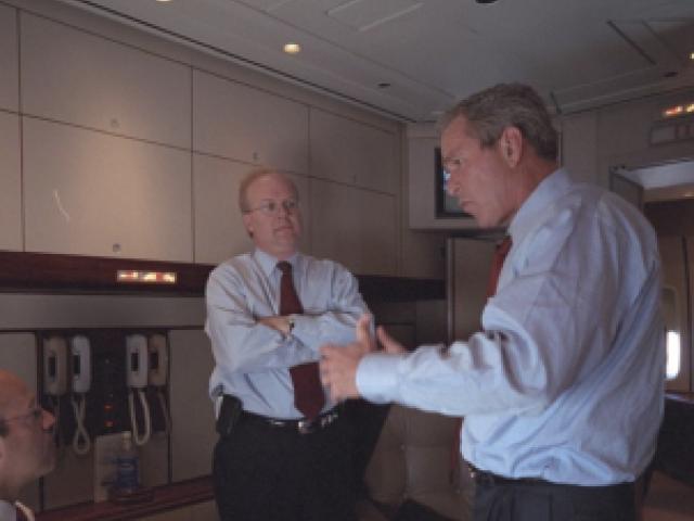  President George W. Bush speaks with Ari Fleischer, left, and Karl Rove aboard Air Force One.