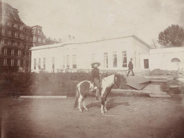 Archie Roosevelt, full-length portrait, on his calico Shetland pony "Algonquin," facing right; in front of the new White House offices. Washington D.C, ca. 1903.